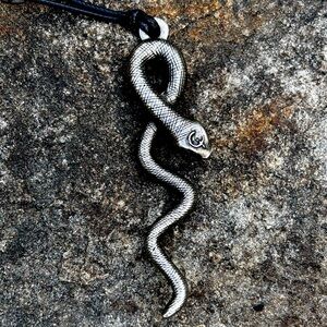 Silver patina snake pendant on black cord necklace, 15-17 inches.